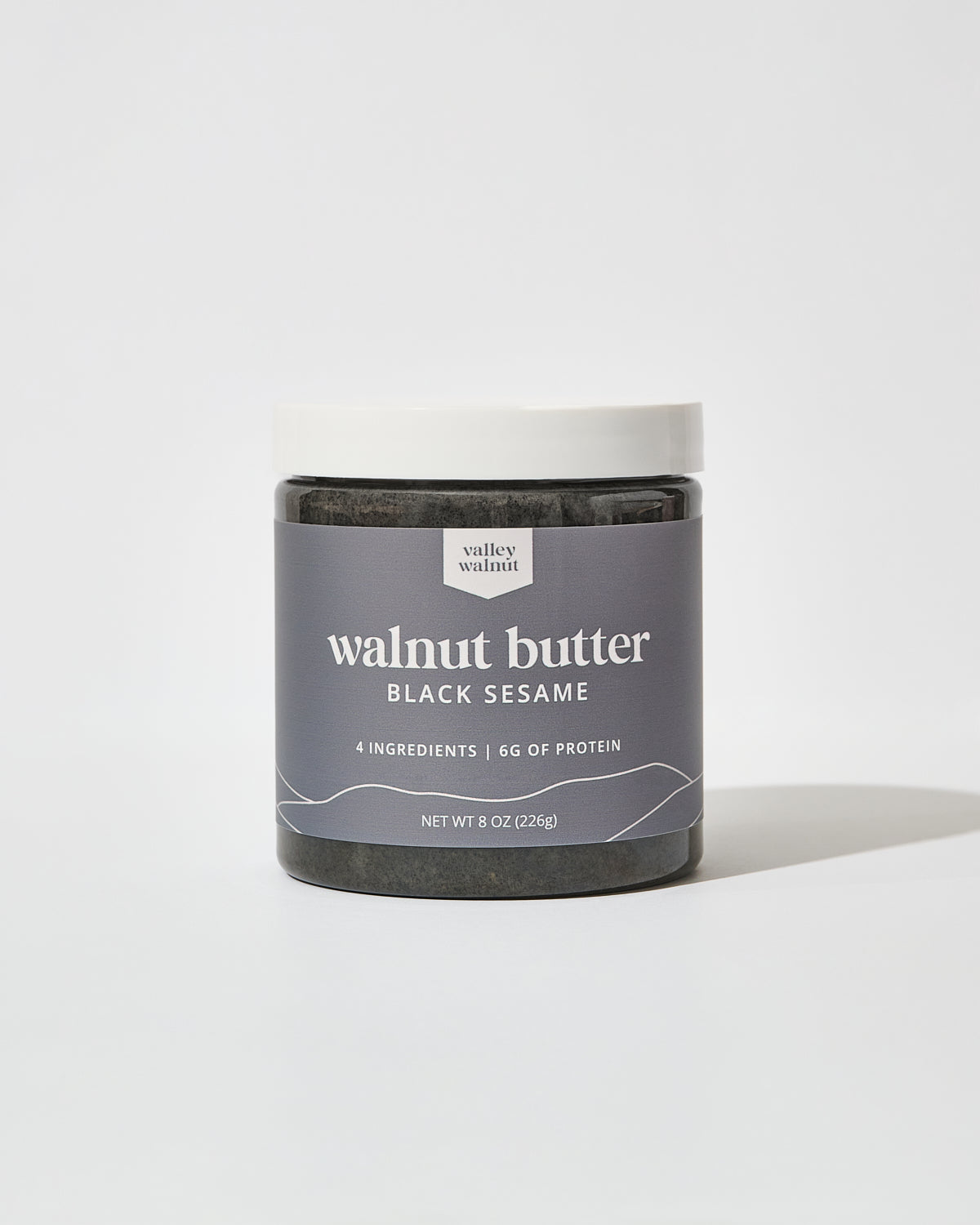 A jar of Valley Walnut Black Sesame Walnut butter on a white background.